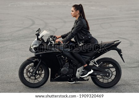 Similar – Image, Stock Photo Young long hair motorbike guy smiling to camera while checking his phone while sitting on his old school motorbike during a break from the road route. Liberty life, young man heavy metal, white tshirt