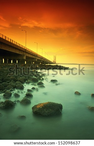 Suramadu bridge beside rocks. Taken at Suramadu Bridge, Surabaya-Madura, east Java, Indonesia