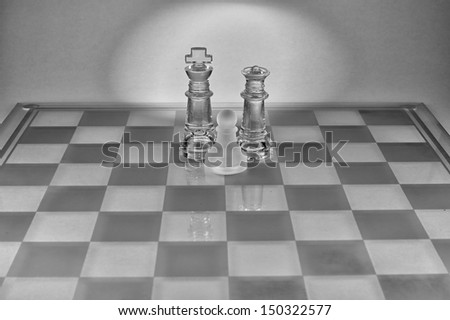 Three chess pieces: Father, mother and son.