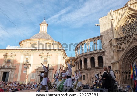 Valencia, Spain - October 9, 2014: Traditional valencian dances at the Virgin\'s Square. Several dancers dressed in traditional costumes are dancing during the celebration of Valencian Community Day.