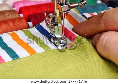 Hand sewing on a machine and item of clothing material