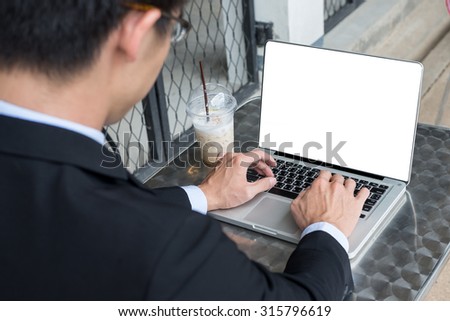 business man concept photo using laptop computer with blank computer screen with selective focus on laptop computer