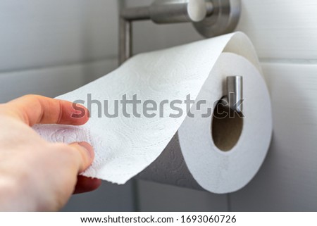 Similar – Image, Stock Photo Man grabs the toilet paper on the toilet