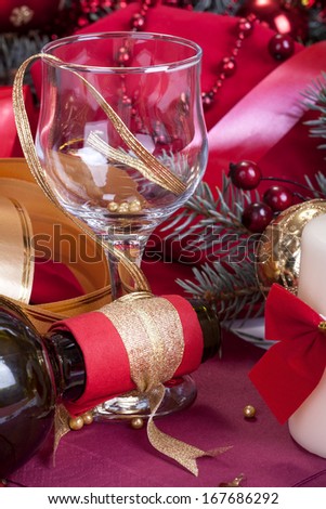 festively decorated glass and a bottle of wine to celebrate the New Year or Christmas
