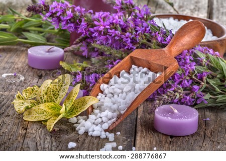 salt bath in wooden spoon with flowers and  leaves in background