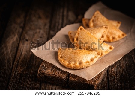 Similar – Image, Stock Photo Tasty stuffed savory pastry pie with phyllo dough in traditional baking pan. Balkan or oriental cuisine. Börek