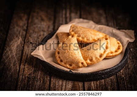 Similar – Image, Stock Photo Tasty stuffed savory pastry pie with phyllo dough in traditional baking pan. Balkan or oriental cuisine. Börek