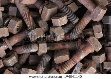 A modest macro shot with a side lighting of an old, rusted nuts and bolts, found in an old, abandoned factory.
