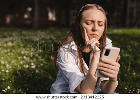 Similar – Image, Stock Photo Serious woman browsing smartphone at home