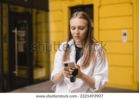 Similar – Image, Stock Photo Serious woman browsing smartphone at home