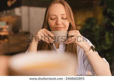 Similar – Image, Stock Photo Pensive woman drinking coffee and browsing smartphone at table