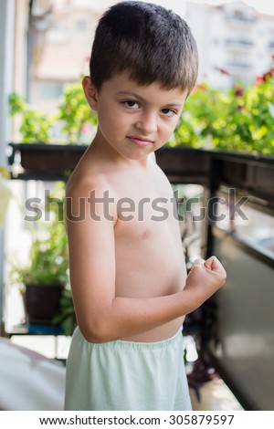 Boy showing his muscles