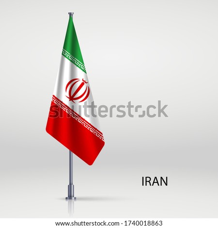 Iran hanging flag on flagpole