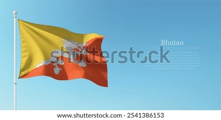 Waving flag of Bhutan on a pole with a blue sky backdrop with copyspace