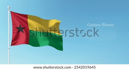 Waving flag of Guinea-Bissau on a pole with a blue sky backdrop with copyspace