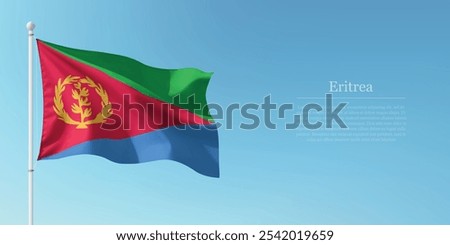 Waving flag of Eritrea on a pole with a blue sky backdrop with copyspace