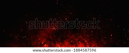 Fire embers particles over black background. Fire sparks background. Abstract dark glitter fire particles lights. bonfire in motion blur. 商業照片 © 