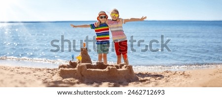 Similar – Image, Stock Photo Little girl building sand castle on beach