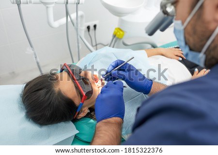 people, medicine, stomatology and health care concept - happy male dentist with woman patient at dental clinic office Stockfoto © 