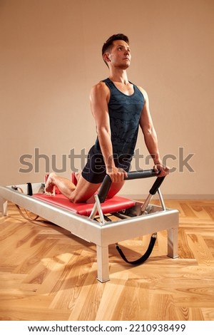 Similar – Image, Stock Photo Sportsman using pilates machine under supervision of female trainer