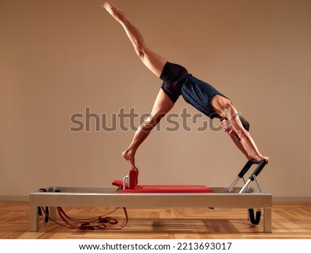 Similar – Image, Stock Photo Sportsman using pilates machine under supervision of female trainer