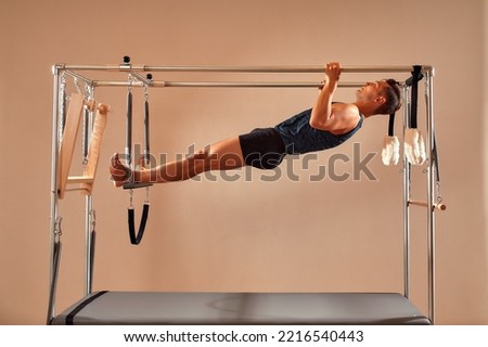 Similar – Image, Stock Photo Sportsman using pilates machine under supervision of female trainer