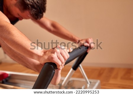 Similar – Image, Stock Photo Sportsman using pilates machine under supervision of female trainer