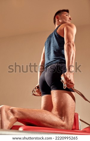 Similar – Image, Stock Photo Sportsman using pilates machine under supervision of female trainer