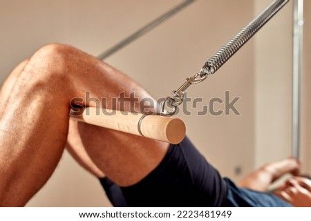 Similar – Image, Stock Photo Sportsman using pilates machine under supervision of female trainer