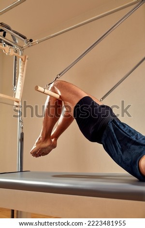 Similar – Image, Stock Photo Sportsman using pilates machine under supervision of female trainer