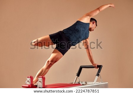 Similar – Image, Stock Photo Sportsman using pilates machine under supervision of female trainer