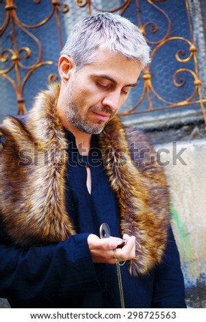 handsome elegant man with pocket watch and wolf fur.