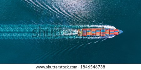 Aerial top view of cargo maritime ship with contrail in the ocean ship carrying container and running for export  concept technology freight shipping by ship smart service 商業照片 © 