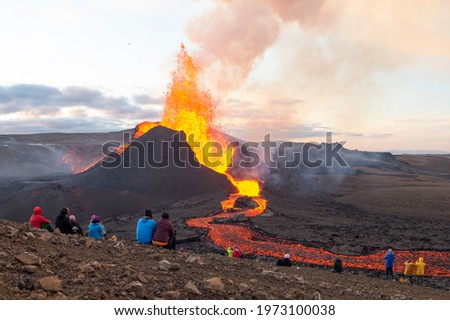 GELDINGADALIR, ICELAND - MAY 11, 2021: A small volcanic eruption has started at the Reykjanes peninsula. The event has attracted thousands of visitors who have braved a daring hike to the crater. 商業照片 © 