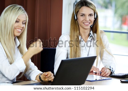 Customer Representative with headset smiling during a telephone conversation