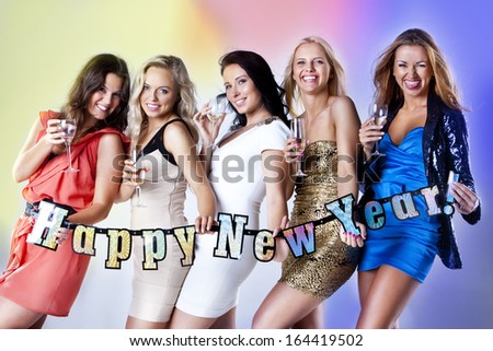 A group of young people dancing at night club. New Year party