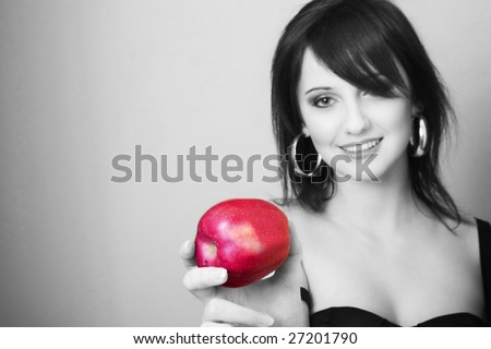 Young woman holding apple and smile, black & white