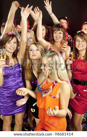 A group of young people dancing at night club.