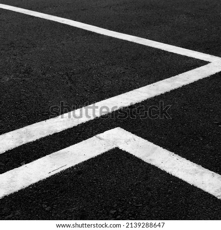 Similar – Image, Stock Photo Two asphalt parking spaces in front of a colourful concrete wall and the shadow of a railing