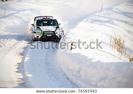 HAGFORS, SWEDEN - FEB 10: Mads Ostberg drivning his Ford Fiesta RS during the World Rally Championship event Rally Sweden in Hagfors, Sweden on Feb 10, 2011