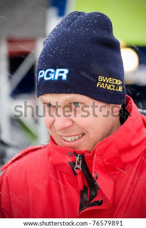 HAGFORS, SWEDEN - FEBRUARY 10: Rally driver Per-Gunnar Andersson greets fans at the service place during the World Rally Championship event 'Rally Sweden 2011