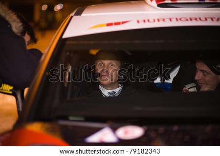 KARLSTAD, SWEDEN - FEB 13: Petter Solberg sitting in the co-driver seat after loosing his driver license, Codriver Chris Patterson drove last stage in  Rally Sweden 2011, on February 13, 2011