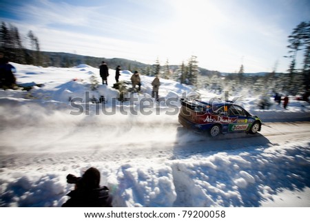 HAGFORS, SWEDEN - FEB 13: Al Qassimi driving his Ford Focus WRC Rally Car in the WRC event Rally Sweden 2010 in Hagfors, Sweden on February 13, 2010.