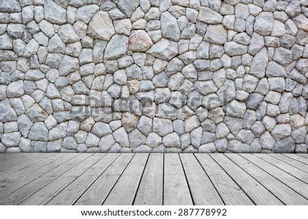 Gray stone wall on wooden floor.
