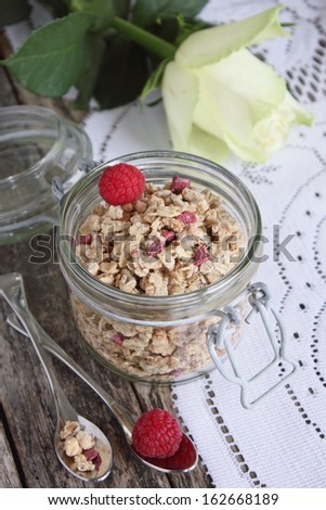 Healthy breakfast with granola and raspberry . Flower.