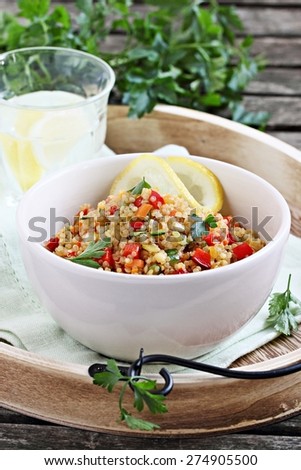 Quinoa salad with vegetables mix,lemon and parsley. Selective focus.