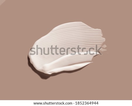 Liquid cream cosmetic smudge texture gray beige background 商業照片 © 