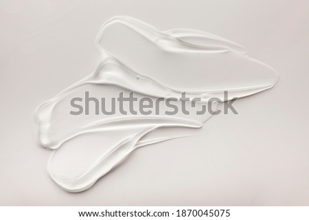 Liquid gel cosmetic smudge drops texture beige grey background  商業照片 © 