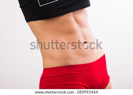 young  female body in fitness sports clothing, with sweat. Athletic woman