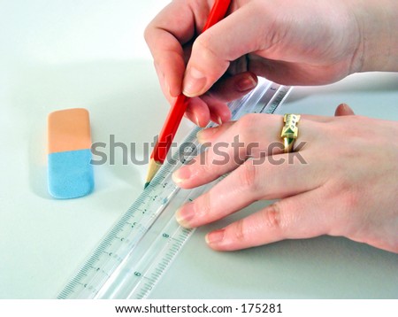 closeup on designer hands with pencil liner and eraser